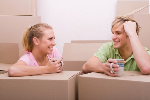 Moving boxes and furniture being loaded into a local removals van