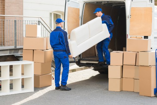 Crew separating cardboard, metals, and reusable goods for recycling in North London