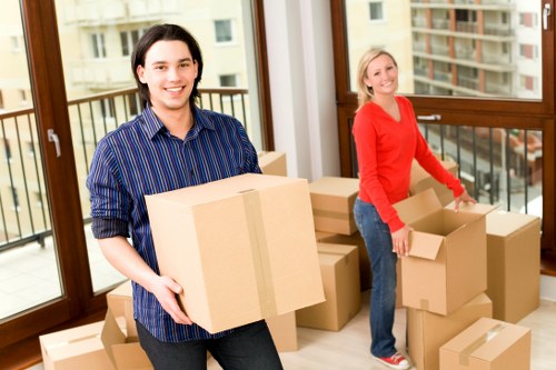 Local movers handling boxes on a Barnsbury street